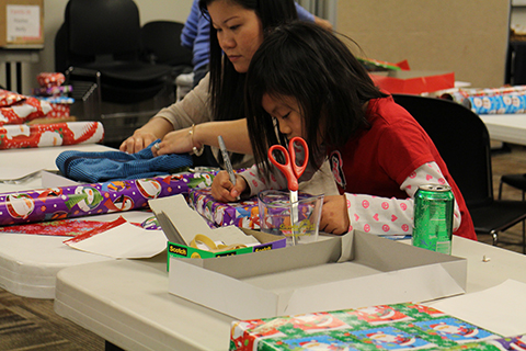 Volunteers wrapping presents for families in need